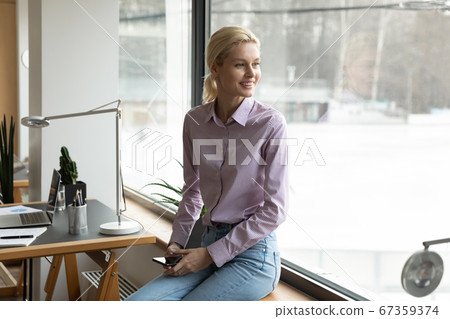 Smiling young woman look in distance visualizing or thinking Smiling young woman look in distance visualizing or thinking 67359374