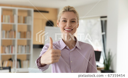 Headshot portrait of smiling businesswoman show thumb up 67359454