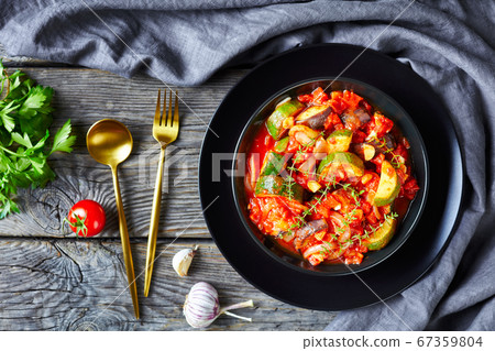 veggies stew in a black bowl 67359804