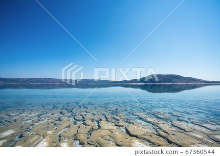 The bottom and surface with crystal clean water of Salda Lake in Turkey. Travel Tourism concept. The bottom and surface with crystal clean water of Salda Lake in Turkey. Travel Tourism concept. 67360544