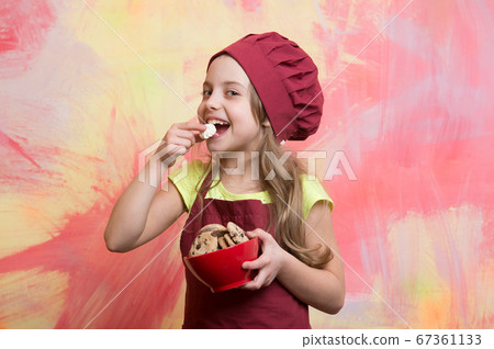 happy small girl eating chocolate cookies dessert 67361133