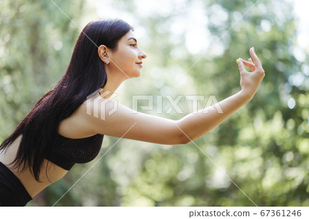 Young woman doing yoga exercises, close up   67361246