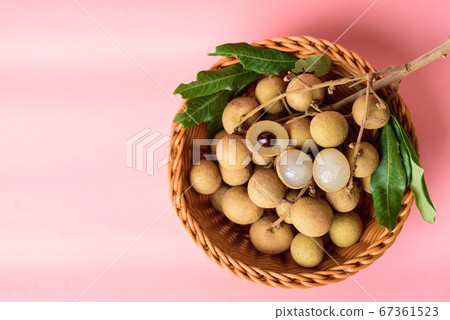 Fresh longan fruit in a basket on pink background Fresh longan fruit in a basket on pink background 67361523