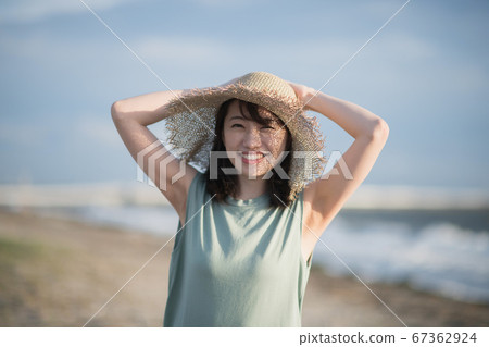 Woman in one piece and straw hat 67362924