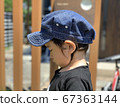 Side profile of a boy standing down in the garden 67363144