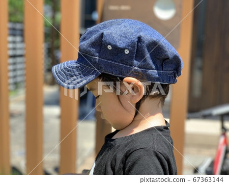 Side profile of a boy standing down in the garden Side profile of a boy standing down in the garden 67363144