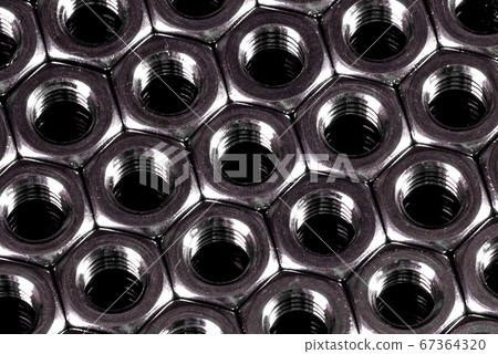 Metal steel nuts laid in composition on a dark 67364320