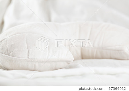White ergonomic pillow in bed. Close up. 67364912