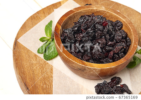 Dried grapes, raisins on wooden background. 67365169