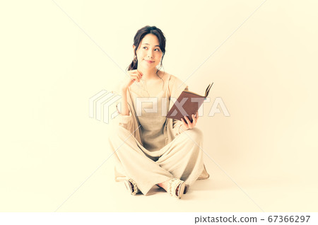 Woman in relax wear with a notebook Woman in relax wear with a notebook 67366297