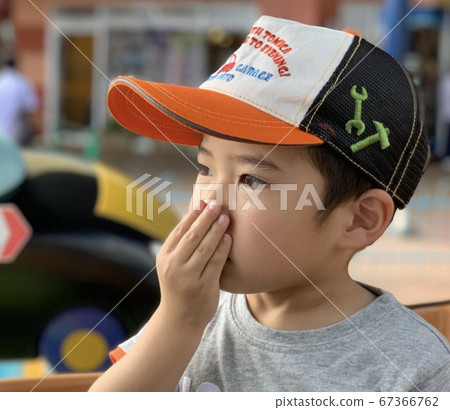 Boy sniffing hands 67366762