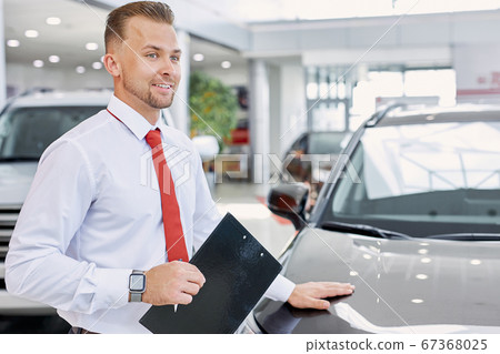 confident smiling car dealer at work confident smiling car dealer at work 67368025