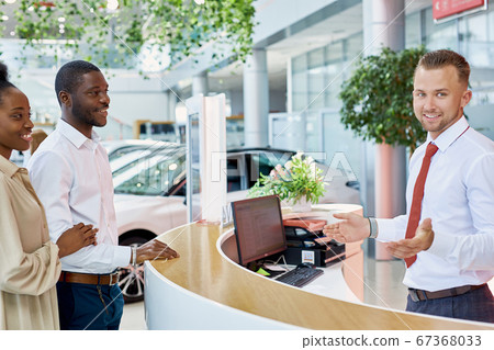 beautiful married couple entered modern dealership 67368033