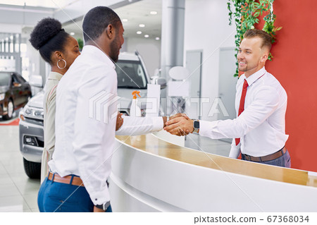 friendly administrator and consultant of dealership welcomes clients 67368034