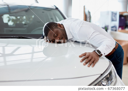 african american man hugs new car he dreams about african american man hugs new car he dreams about 67368077