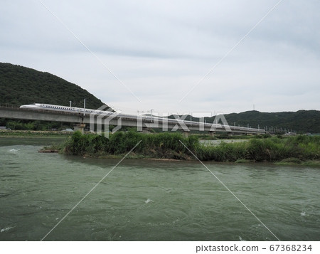Sanyo Shinkansen N700 Series Shinkansen Nozomi across the Chikusa River Bridge 67368234