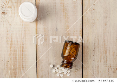 Home medicine.Glass bottles of medicine and roubd white pills Home medicine.Glass bottles of medicine and roubd white pills 67368330