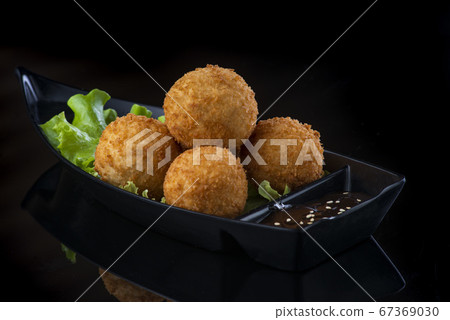 A box filled with different types of food. cheese balls A box filled with different types of food. cheese balls 67369030