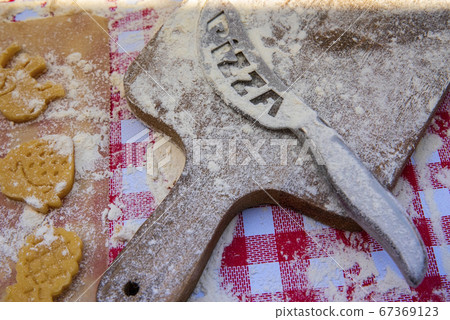 White flour on rustic wooden cutting board , top view White flour on rustic wooden cutting board , top view 67369123