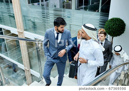 Business people discussing their ideas climbing stairs Business people discussing their ideas climbing stairs 67369398