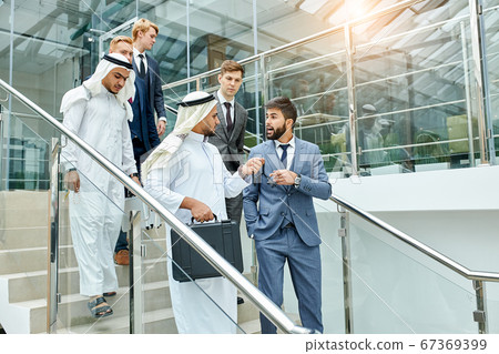sheikhs and caucasians after successful business meeting sheikhs and caucasians after successful business meeting 67369399