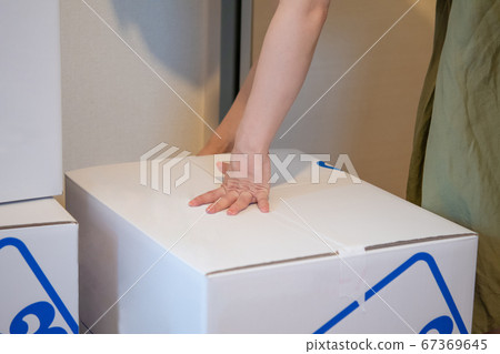 Image of holding down moving cardboard Image of holding down moving cardboard 67369645