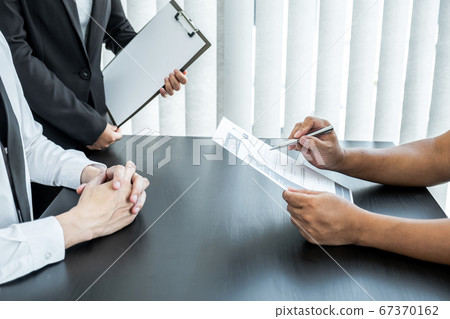 Office executives are interviewing job applicants in the meeting room Office executives are interviewing job applicants in the meeting room 67370162