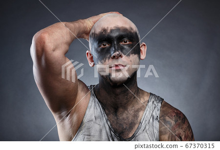 Image of bald dirty man with hand on head Image of bald dirty man with hand on head 67370315