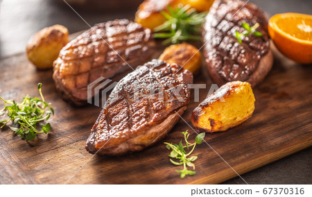 Detail of tasty roasted duck breasts and potatoes Detail of tasty roasted duck breasts and potatoes 67370316