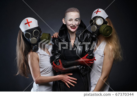 Photo of three women in role play - nurses and evil one 67370344