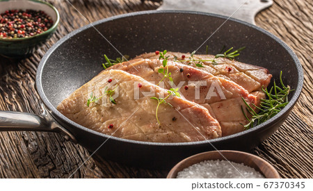Seared duck breasts with seasonings in a pan on a 67370345