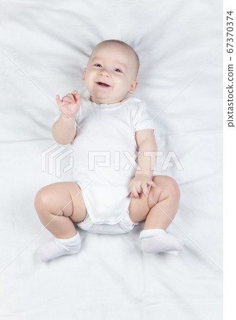 Picture of a six-month-old baby on a white background Picture of a six-month-old baby on a white background 67370374