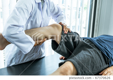 Physical therapy is doing leg therapy for patients in the hospital 67370626