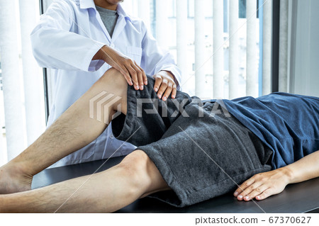 Physical therapy is doing leg therapy for patients in the hospital 67370627
