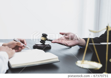 The male lawyer is providing service to consult business disputes to businessmen The male lawyer is providing service to consult business disputes to businessmen 67370731