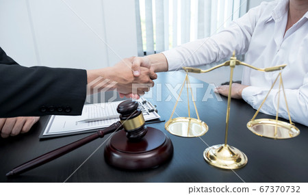 handshake after The male lawyer is providing service to consult business disputes to businessmen handshake after The male lawyer is providing service to consult business disputes to businessmen 67370732