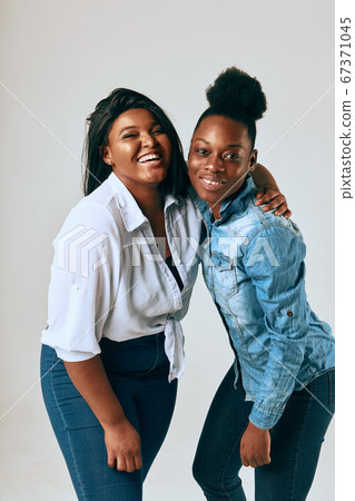 Two College Friends Smiling and Looking at the Camera Two College Friends Smiling and Looking at the Camera 67371045