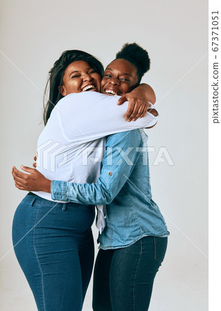 Two College Friends Smiling and Looking at the Camera Two College Friends Smiling and Looking at the Camera 67371051