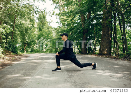 Sports man in a morning summer park Sports man in a morning summer park 67371383