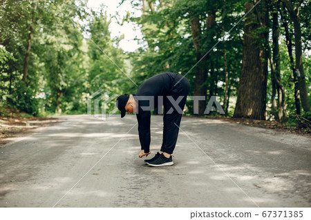 Sports man in a morning summer park Sports man in a morning summer park 67371385