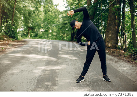 Sports man in a morning summer park Sports man in a morning summer park 67371392