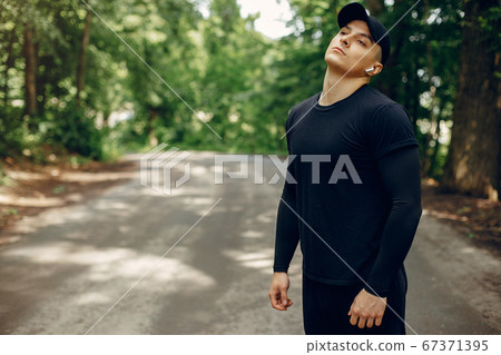 Sports man in a morning summer park Sports man in a morning summer park 67371395