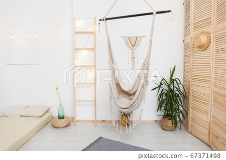 living room with hammock and white walls 67371498