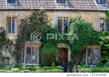 Castle Combe is a village and civil parish within the Cotswolds Area of Natural Beauty in Wiltshire. England, UK, July 11, 2020 Castle Combe is a village and civil parish within the Cotswolds Area of Natural Beauty in Wiltshire. England, UK, July 11, 2020 67371690