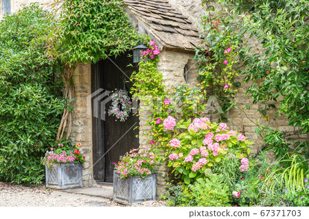 Castle Combe is a village and civil parish within the Cotswolds Area of Natural Beauty in Wiltshire. England, UK, July 11, 2020 Castle Combe is a village and civil parish within the Cotswolds Area of Natural Beauty in Wiltshire. England, UK, July 11, 2020 67371703