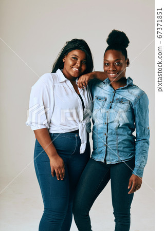 Two College Friends Smiling and Looking at the Camera Two College Friends Smiling and Looking at the Camera 67371851