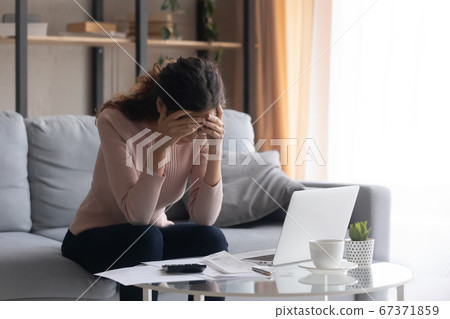 Upset young woman frustrated with financial problems Upset young woman frustrated with financial problems 67371859