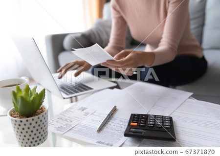 Close up of woman pay bills taxes on laptop Close up of woman pay bills taxes on laptop 67371870