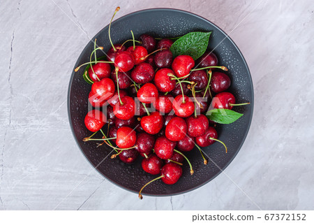 Cherry with leaf on plate and water dropsand on Cherry with leaf on plate and water dropsand on 67372152
