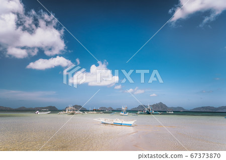 A traditional Filipino boat on an empty sandy bar A traditional Filipino boat on an empty sandy bar 67373870